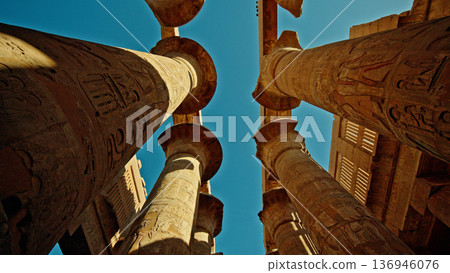 Ancient columns of Karnak Temple in Luxor Egypt viewed from below at sunset Ancient columns of Karnak Temple in Luxor Egypt viewed from below at sunset 136946076
