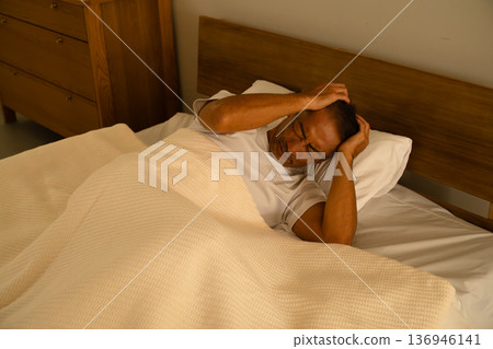 Senior man sleeping in bed Lifestyle image Senior man sleeping in bed Lifestyle image 136946141