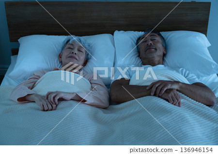 Senior couple sleeping in bed Lifestyle image Senior couple sleeping in bed Lifestyle image 136946154
