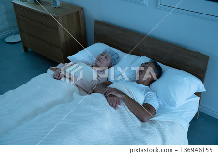 Senior couple sleeping in bed Lifestyle image Senior couple sleeping in bed Lifestyle image 136946155