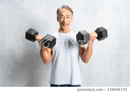 Senior man holding dumbbells Sports image 136946170