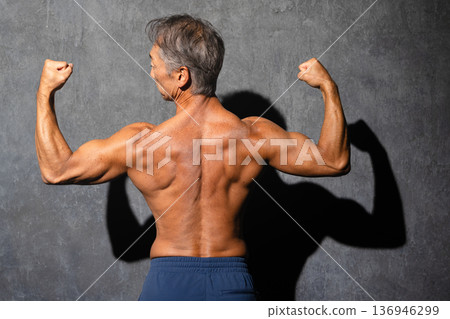 Senior man posing shirtless in bodybuilding poses Sports image Senior man posing shirtless in bodybuilding poses Sports image 136946299