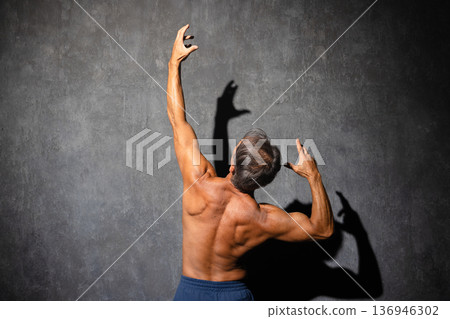 Senior man posing shirtless in bodybuilding poses Sports image 136946302