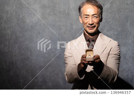 Senior man holding a ring Lifestyle image Senior man holding a ring Lifestyle image 136946357