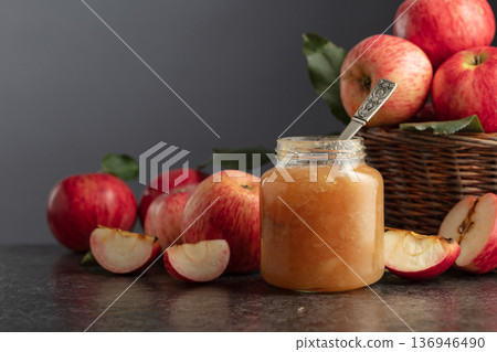 Apple jam and fresh apples on a black stone table. 136946490