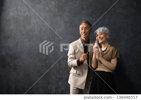Senior men and women singing with a microphone Lifestyle image Senior men and women singing with a microphone Lifestyle image 136946557