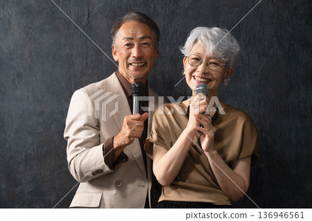 Senior men and women singing with a microphone Lifestyle image Senior men and women singing with a microphone Lifestyle image 136946561