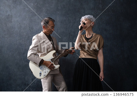 A woman singing and a man playing the guitar Lifestyle image 136946575