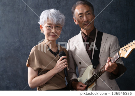 A woman singing and a man playing the guitar Lifestyle image 136946586