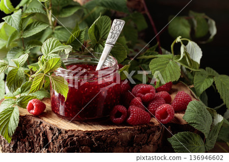 Jar of raspberry jam and fresh berries with leaves. Jar of raspberry jam and fresh berries with leaves. 136946602