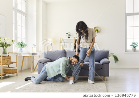 Couple quarrel and breakup at home, clingy man pleading with woman not to leave Couple quarrel and breakup at home, clingy man pleading with woman not to leave 136946779