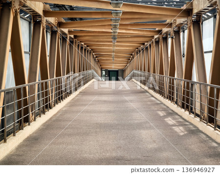 Walking path on a metal bridge in an urban area during the daytime Walking path on a metal bridge in an urban area during the daytime 136946927