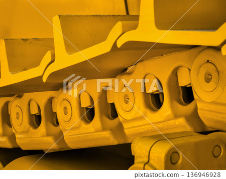 A close view of yellow tracks for heavy machinery rests 136946928