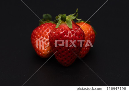 Black background and bright red strawberry stock photo Black background and bright red strawberry stock photo 136947196