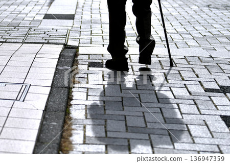 Yokohama cityscape in Japan, steps... elderly man with a cane... dark shadows swaying on the dangerous sidewalk... what is life... 136947359