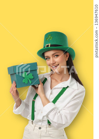 Woman holds a box while wearing a green hat for celebration Woman holds a box while wearing a green hat for celebration 136947610