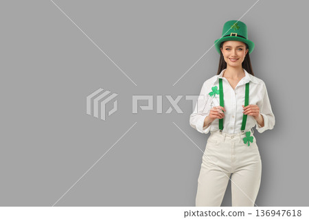 A young woman is dressed in green with shamrock details A young woman is dressed in green with shamrock details 136947618