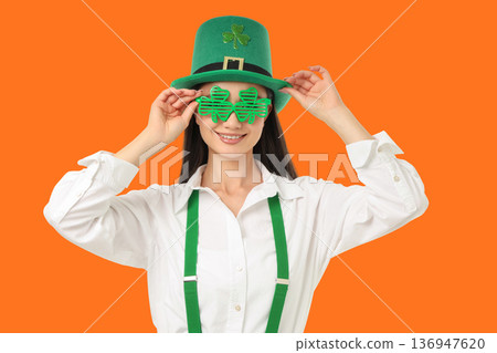 Woman wears green hat and glasses for St. Patrick's Day fun 136947620