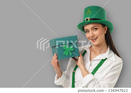 A young woman wears a green hat and holds a box for St. Patrick's Day A young woman wears a green hat and holds a box for St. Patrick's Day 136947622