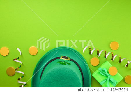 Green hat with a shamrock beside gold coins and a wrapped gift Green hat with a shamrock beside gold coins and a wrapped gift 136947624
