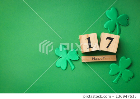 Wooden calendar showing March 17 surrounded by green shamrocks 136947633