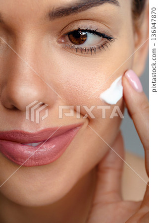 Skin care. Woman with beauty face touching healthy facial skin portrait. Beautiful smiling girl model with natural makeup touching glowing hydrated skin. Skin care. Woman with beauty face touching healthy facial skin portrait. Beautiful smiling girl model with natural makeup touching glowing hydrated skin. 136947870