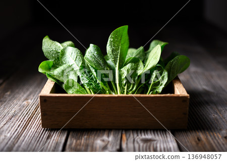 Freshly washed spinach leaves collected in wooden storage box Freshly washed spinach leaves collected in wooden storage box 136948057