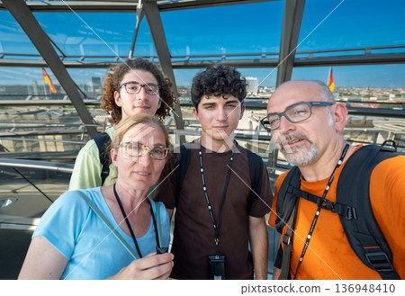 Berlin, germany, august 15, 2023. Family exploring the reichstag glass dome in berlin, enjoying city views, sunny summer sightseeing and cultural discovery together Berlin, germany, august 15, 2023. Family exploring the reichstag glass dome in berlin, enjoying city views, sunny summer sightseeing and cultural discovery together 136948410