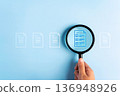 Close up to hand, hold magnifier to search file to management about document is important business. 136948926
