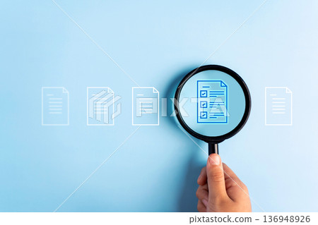 Close up to hand, hold magnifier to search file to management about document is important business. 136948926