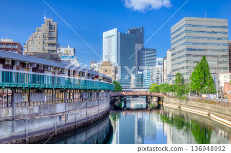 Harmonica Yokocho and skyscrapers as seen from Miyagawa Bridge in Yokohama 136948992