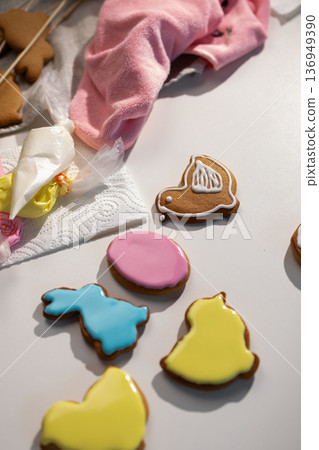 Decorating Festive Easter Gingerbread Cookies With Colorful Icing for Celebration Decorating Festive Easter Gingerbread Cookies With Colorful Icing for Celebration 136949390