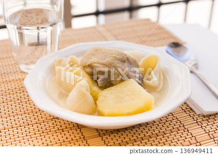 chicken broth soup with chicken, potatoes, and pasta shells chicken broth soup with chicken, potatoes, and pasta shells 136949411