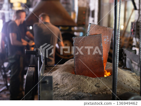 Foundry - ferrous metal is melted in an induction furnace of metallurgical plant 136949462