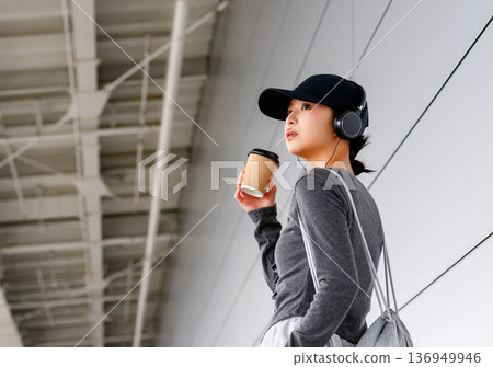 A woman drinking coffee at the airport. Photo courtesy of Kansai International Airport (KIX). A woman drinking coffee at the airport. Photo courtesy of Kansai International Airport (KIX). 136949946