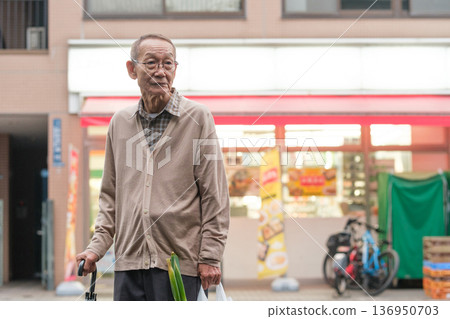 Senior man returning from shopping in the evening, lost 136950703