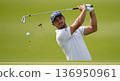 A high-action, professional sports photograph capturing a dynamic moment in a game of Golf. The image clearly shows a player making in sharp focus 136950961