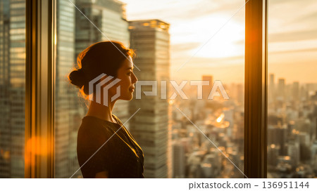 晨曦照耀下,一位事業有成的女性,象徵成功和遠見。 晨曦照耀下,一位事業有成的女性,象徵成功和遠見。 136951144