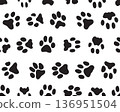 Black silhouettes of prints of dog paws, Seamless pattern 136951504