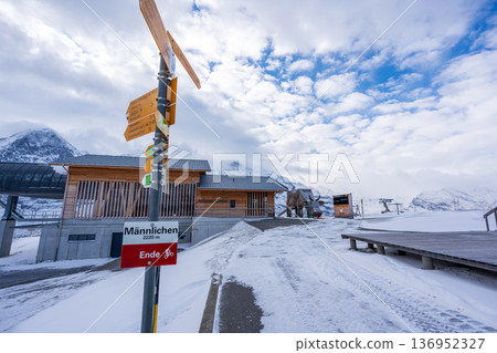 Männlichen Gondola Station with snowy mountains in the background. Grindelwald, canton of Bern, Switzerland Männlichen Gondola Station with snowy mountains in the background. Grindelwald, canton of Bern, Switzerland 136952327