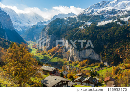 Staubbach Falls and snow-capped mountains seen from Wengen, Canton of Bern, Switzerland 136952370