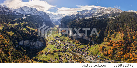 Aerial panorama of the U-shaped valley of Lauterbrunnen with steep cliffs, waterfalls and autumn forest. Lauterbrunnen, canton of Bern, Switzerland Aerial panorama of the U-shaped valley of Lauterbrunnen with steep cliffs, waterfalls and autumn forest. Lauterbrunnen, canton of Bern, Switzerland 136952373
