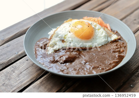 European-style beef curry topped with carrot rapée and fried egg 136952459