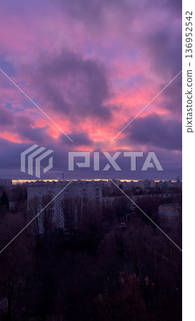 Red cloudy sky over a big city at sunset.  136952542