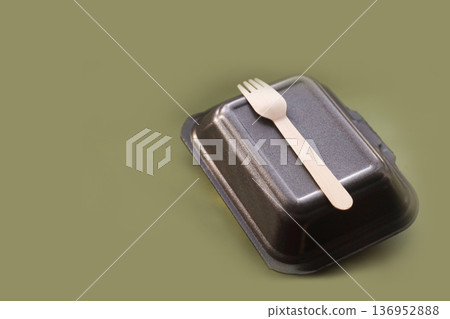 Biodegradable food container with wooden cutlery on olive background, zero waste and eco lifestyle theme Biodegradable food container with wooden cutlery on olive background, zero waste and eco lifestyle theme 136952888