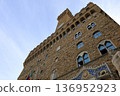 The towers of Palazzo Vecchio towering under the blue sky 136952923