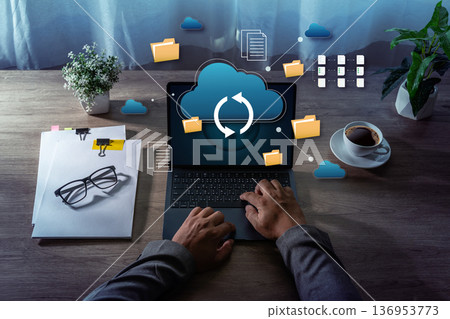 Cloud Storage Data Synchronization File Management on Laptop cloud storage and data synchronization icons representing business technology and remote work. 136953773