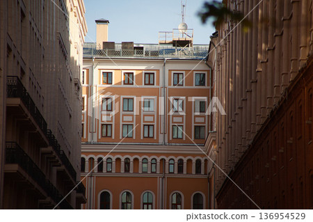 Classic European Architecture Facade Framed by Urban Buildings 136954529