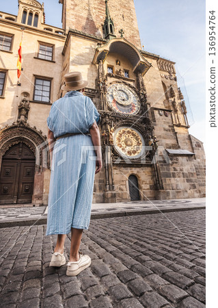 Woman tourist looking at Prague Astronomical Clock on Old Town Hall in Prague, Czech Republic historic landmark Woman tourist looking at Prague Astronomical Clock on Old Town Hall in Prague, Czech Republic historic landmark 136954764