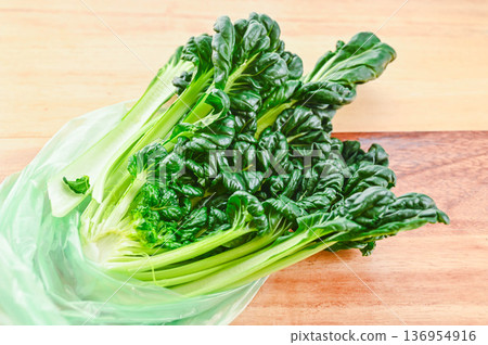 Tatsoi in a bag to keep it fresh Tatsoi in a bag to keep it fresh 136954916
